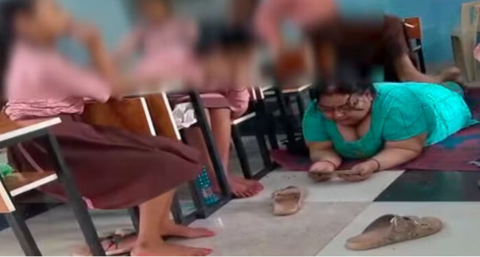 ക്ലാസ് മുറിയില്‍ ഫോണും നോക്കി കമിഴ്ന്ന് കിടന്നു, വിദ്യാര്‍ത്ഥിനികളെ കൊണ്ട് ശരീരം ചവിട്ടി തിരുമ്മിപ്പിച്ച് പ്രധാനാധ്യാപിക, വീഡിയോ വൈറലായതിനു പിന്നാലെ സസ്പെന്‍ഷന്‍, ഒടുവില്‍ എഐ വീഡിയോയാണെന്ന് പറഞ്ഞ് തടിയൂരാന്‍ ശ്രമം
