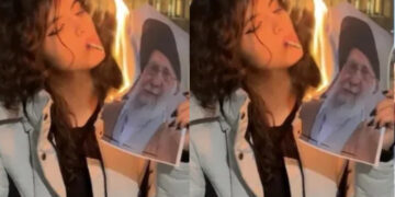 ഞങ്ങൾ നിങ്ങളുടെ കുഴിമാടത്തിൽ നൃത്തം ചെയ്യുമെന്ന് ഞാൻ പറഞ്ഞില്ലേ? ഒരു എലിയേ പോലുള്ള അവസാനം… ആഹ്ലാദപ്രടകനവുമായി ഖമനേയിയുടെ ചിത്രം കത്തിച്ച് സിഗരറ്റ് വലിച്ച യുവതി